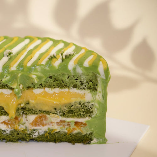 Cross-section of Jasmine Lime Citrus Matcha Cake by at sucré Singapore - vibrant matcha cream layers