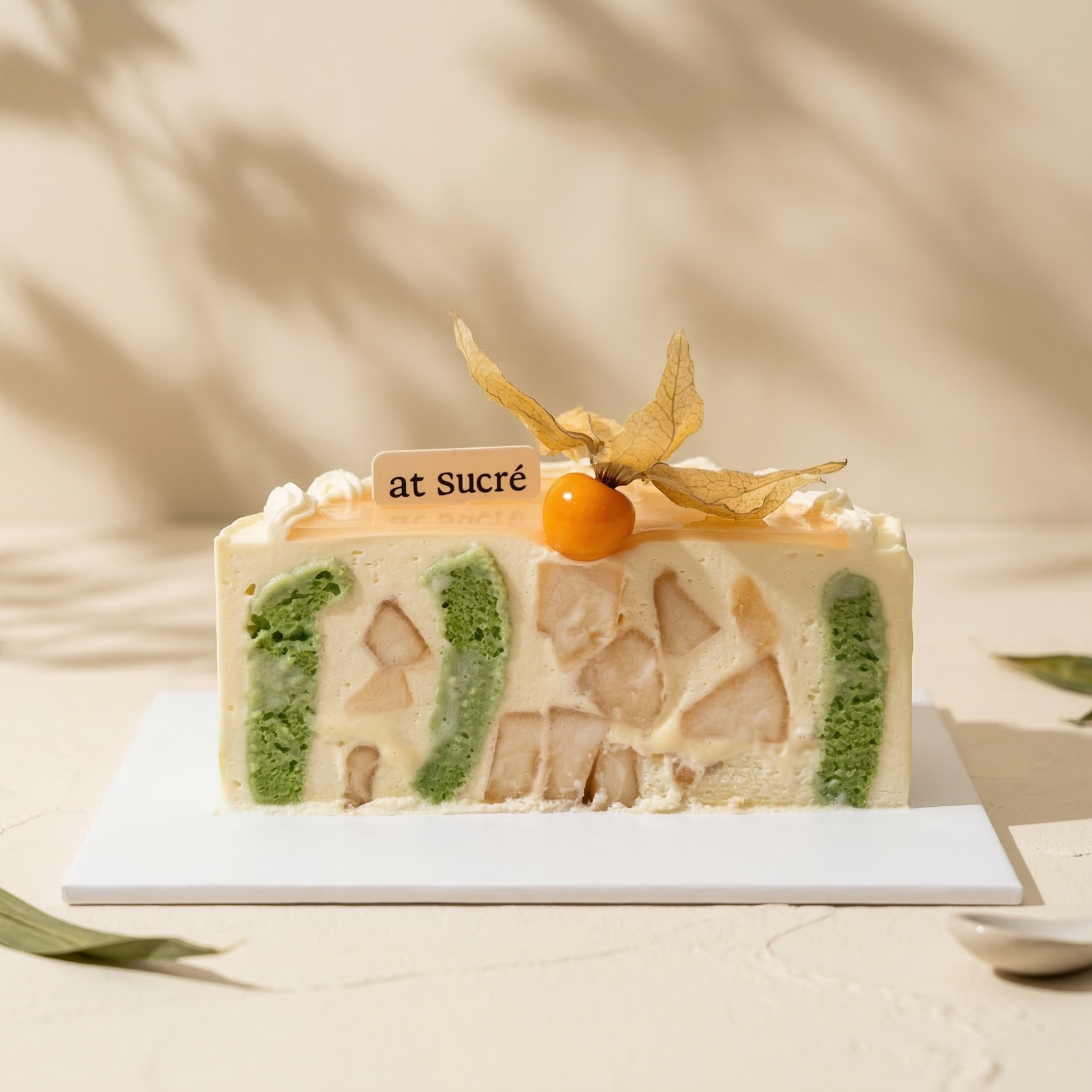 Cross-section of Pear and Pandan Glutinous Rice Cake by at sucré Singapore - layered fresh cream cake
